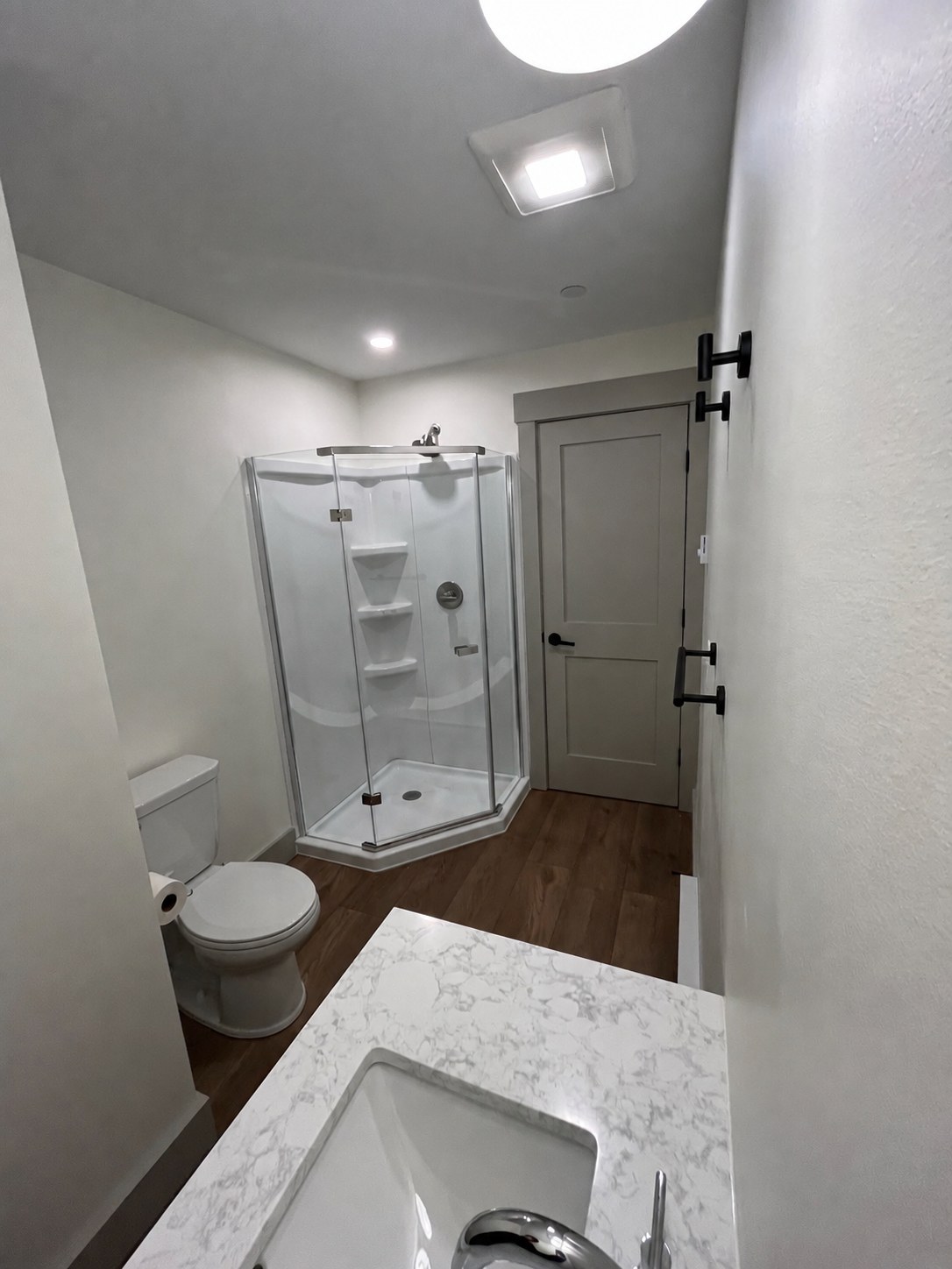 Bathroom with glass shower and quartz vanity at 114 Silver St