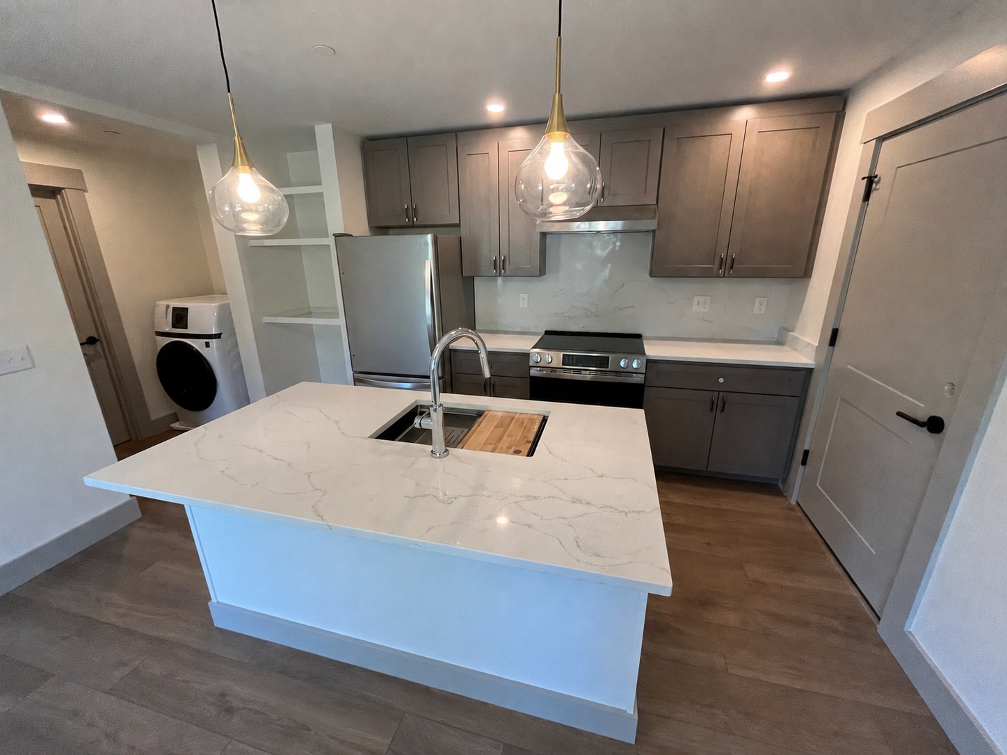 Kitchen with quartz island and washer at 114 Silver St
